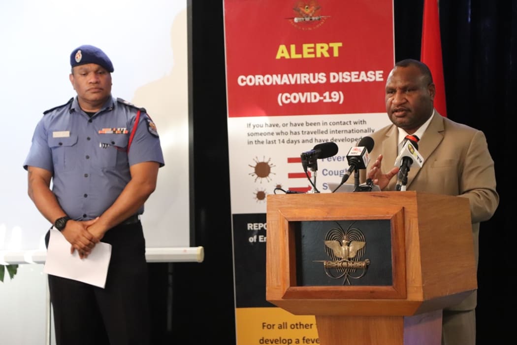 Papua New Guinea's Prime Minister James Marape (right) updates media on the countries covid-19 response, alongside the Emergency Controller, Police Commissioner David Manning.