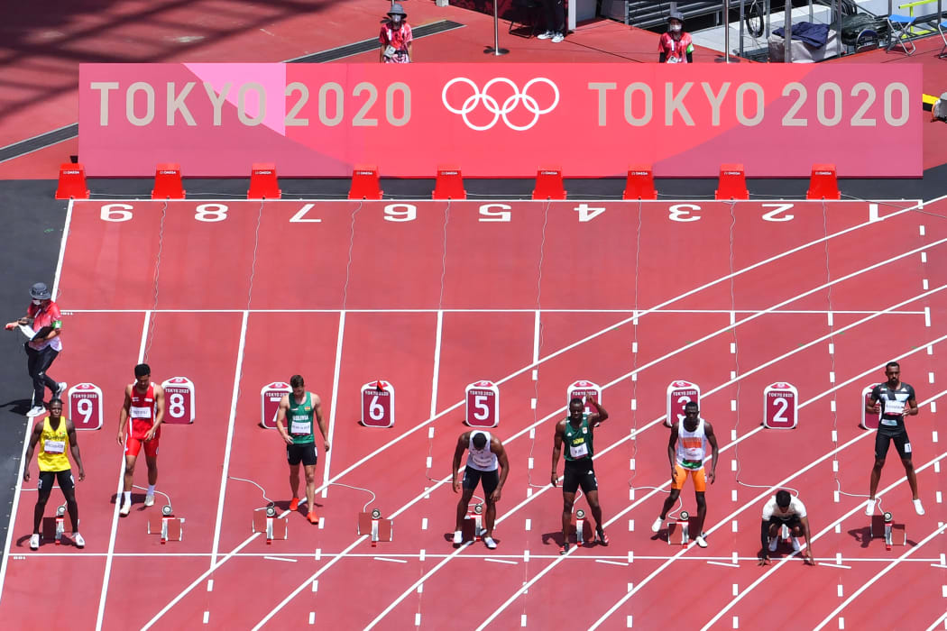 Tonga's Ronald Fotofili (2L) competing in the men's 100m heats during the Tokyo 2020 Olympic Games.