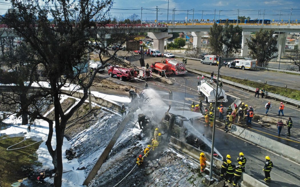 Mexican firefighters extinguish the flames of a gas truck that exploded in Mexico City on September 10, 2025. Nearly 60 people were wounded, 19 gravely, when a gas truck exploded in Mexico City, causing widespread damage, municipal officials said.