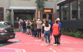 A queue forms for an open home viewing at Leeds Street apartments in Wellington.