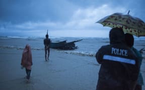 People come to see the boat where Rohingya Muslim refugees were found dead on the shore of Inani beach, near Cox's Bazar.