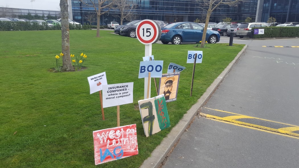 Protest signs outside IAG's Christchurch office.