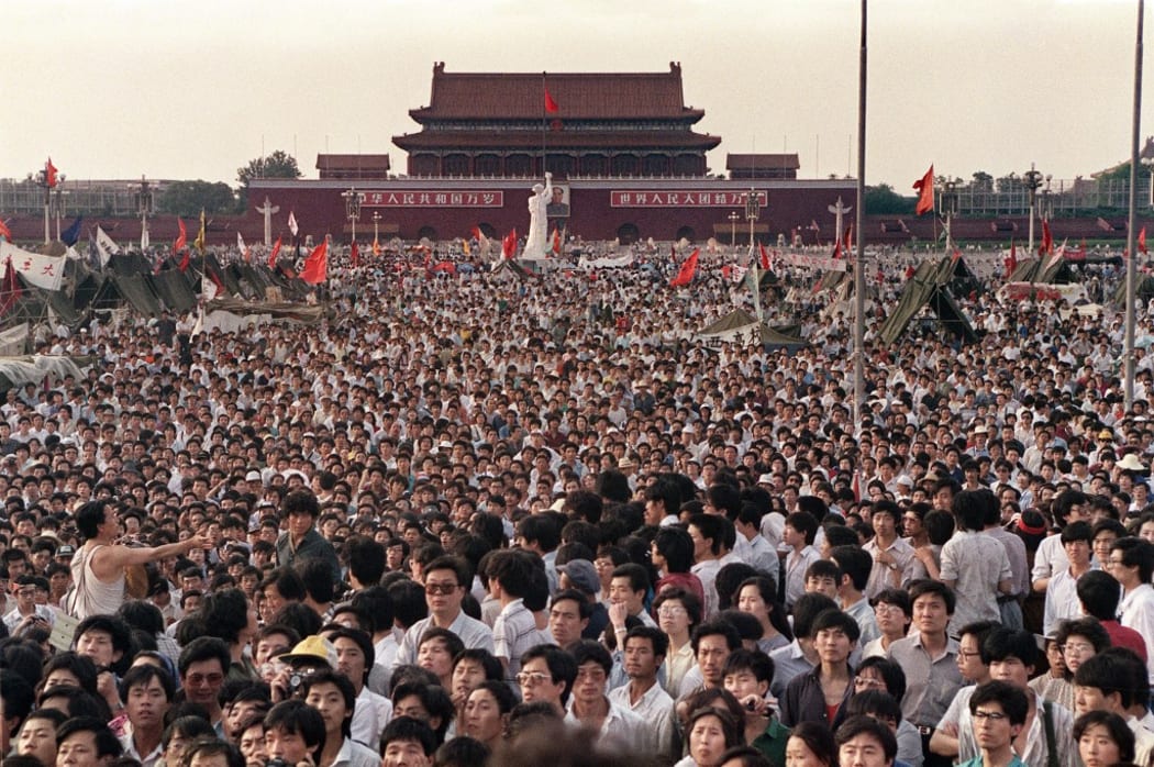 (FILES) This file photo taken on June 2, 1989 shows people gathered at Tiananmen Square during a pro-democracy protest in Beijing. -