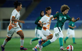Saudi Arabia's Seba Tawfiq (green) runs with the ball during a friendly football match against Bhutan in Abha on September 24, 2022.