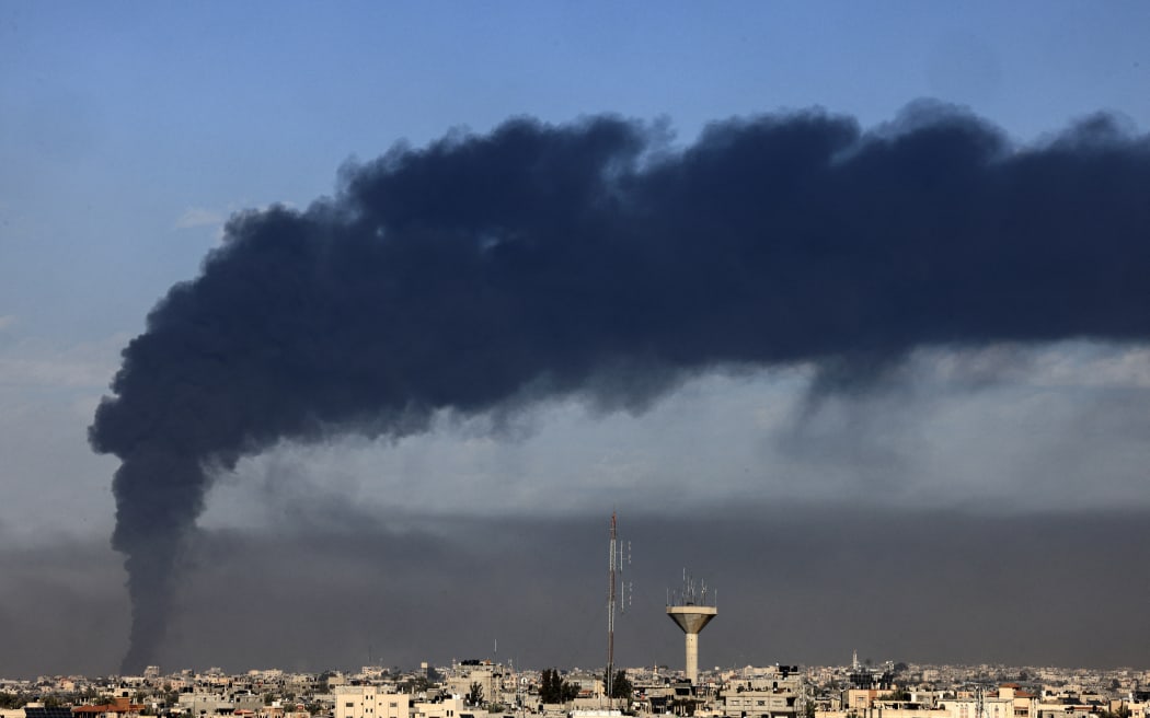 A picture taken from Rafah shows smoke billowing over Khan Yunis in the southern Gaza Strip during Israeli bombardment on January 21, 2024, amid ongoing battles between Israel and the Palestinian militant group Hamas. (Photo by AFP)