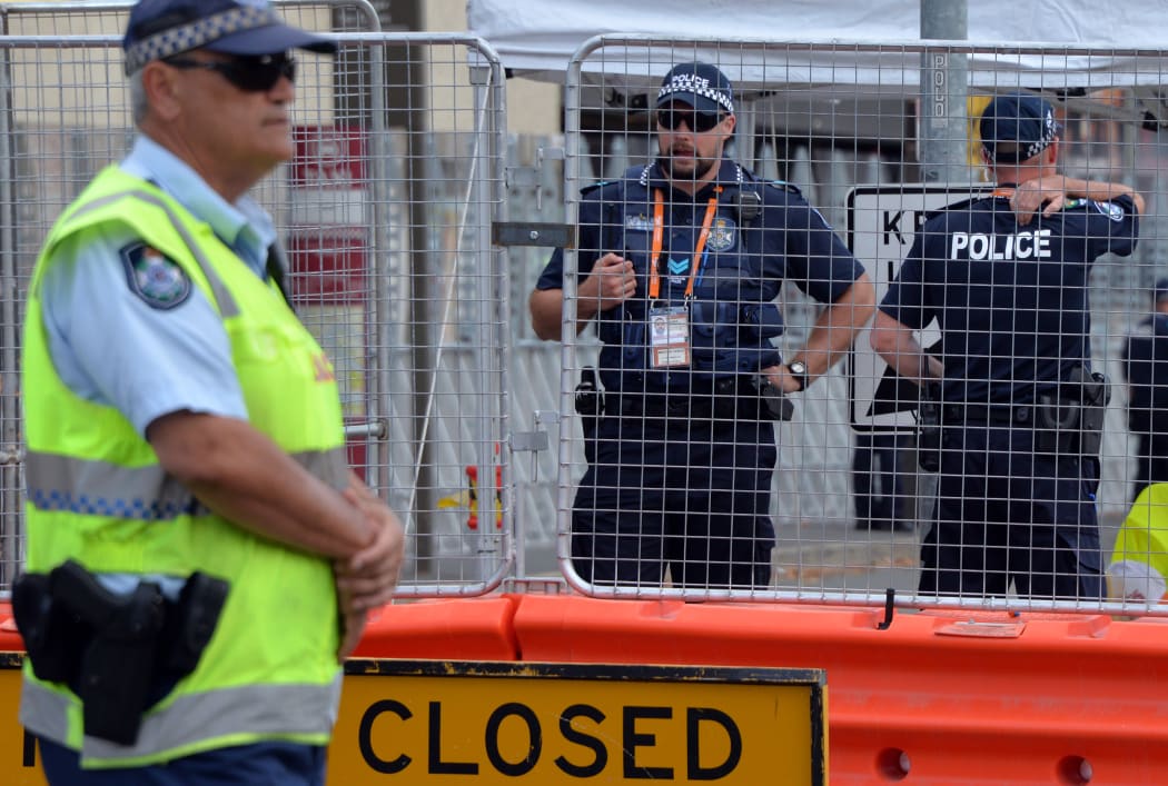 Queensland police stand guard outside summit venue Brisbane Exhibition and Convention Centre.