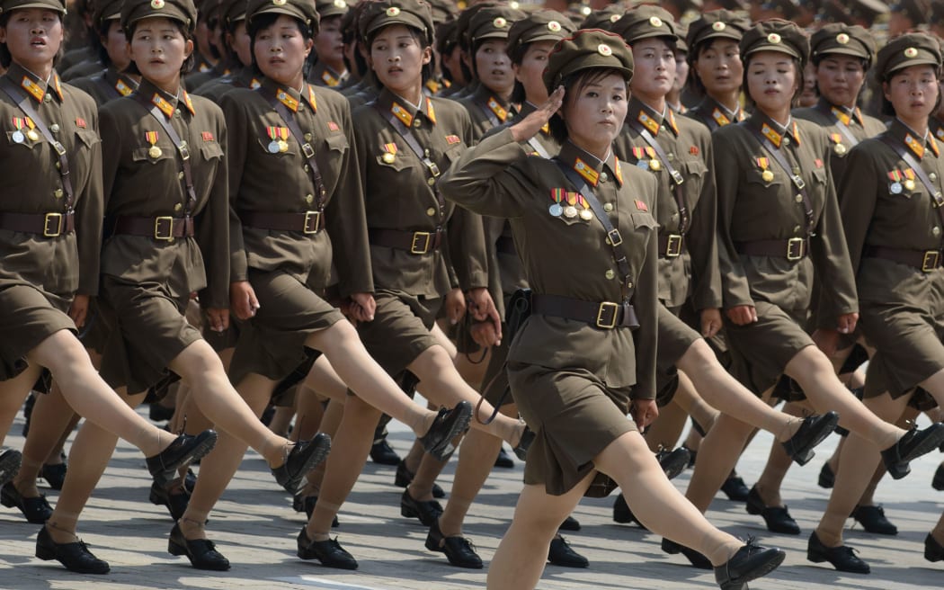Female North Korean soldiers march through Kim Il-Sung square during a military parade.