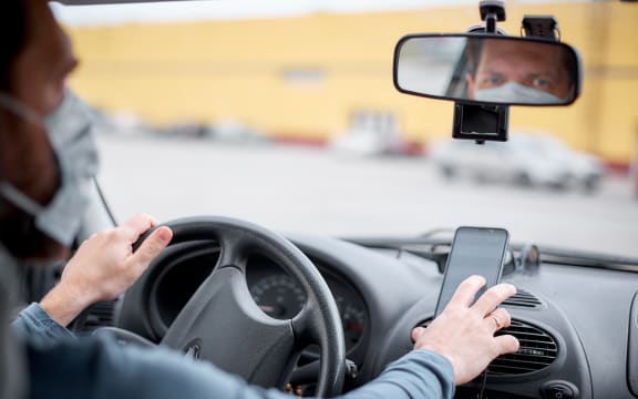 Taxi driver using phone for navigation.