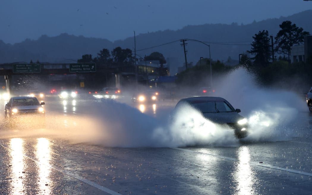 Cars drive along Highway 101 as rain falls on January 04, 2023 in Greenbrae, California.