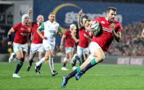 Lions' Jared Payne makes a break with the ball, scoring the team's fourth try of the match.