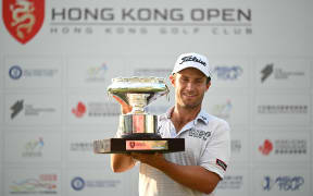 New Zealand's Ben Campbell celebrates with the winner's trophy after his victory on the final day of the Hong Kong Open at Fanling golf club in Hong Kong on November 12, 2023. (Photo by Peter PARKS / AFP)