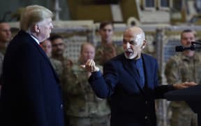 File photo taken on November 28, 2019 Afghan President Ashraf Ghani addresses US troops during a surprise Thanksgiving day visit of US President Donald Trump at Bagram Air Field,in Afghanistan.