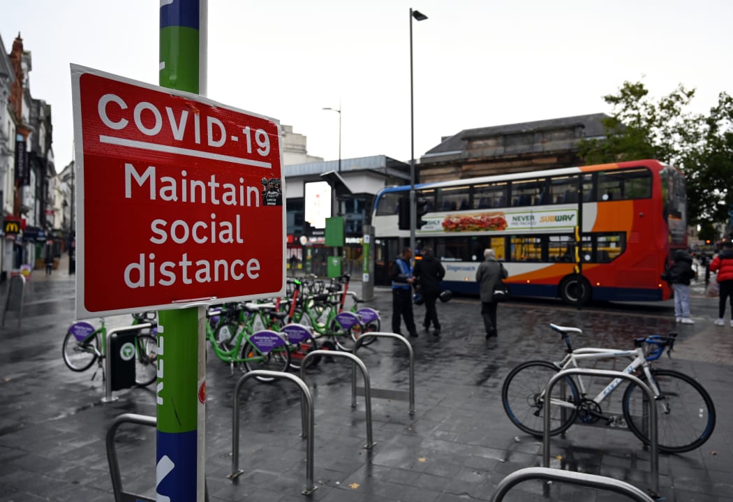 A street sign advises members of the public to "Maintain Social Distance" in Liverpool, north west England on October 12, 2020, as new local lockdown measures are set to be imposed to help stem a second wave of Covid-19.