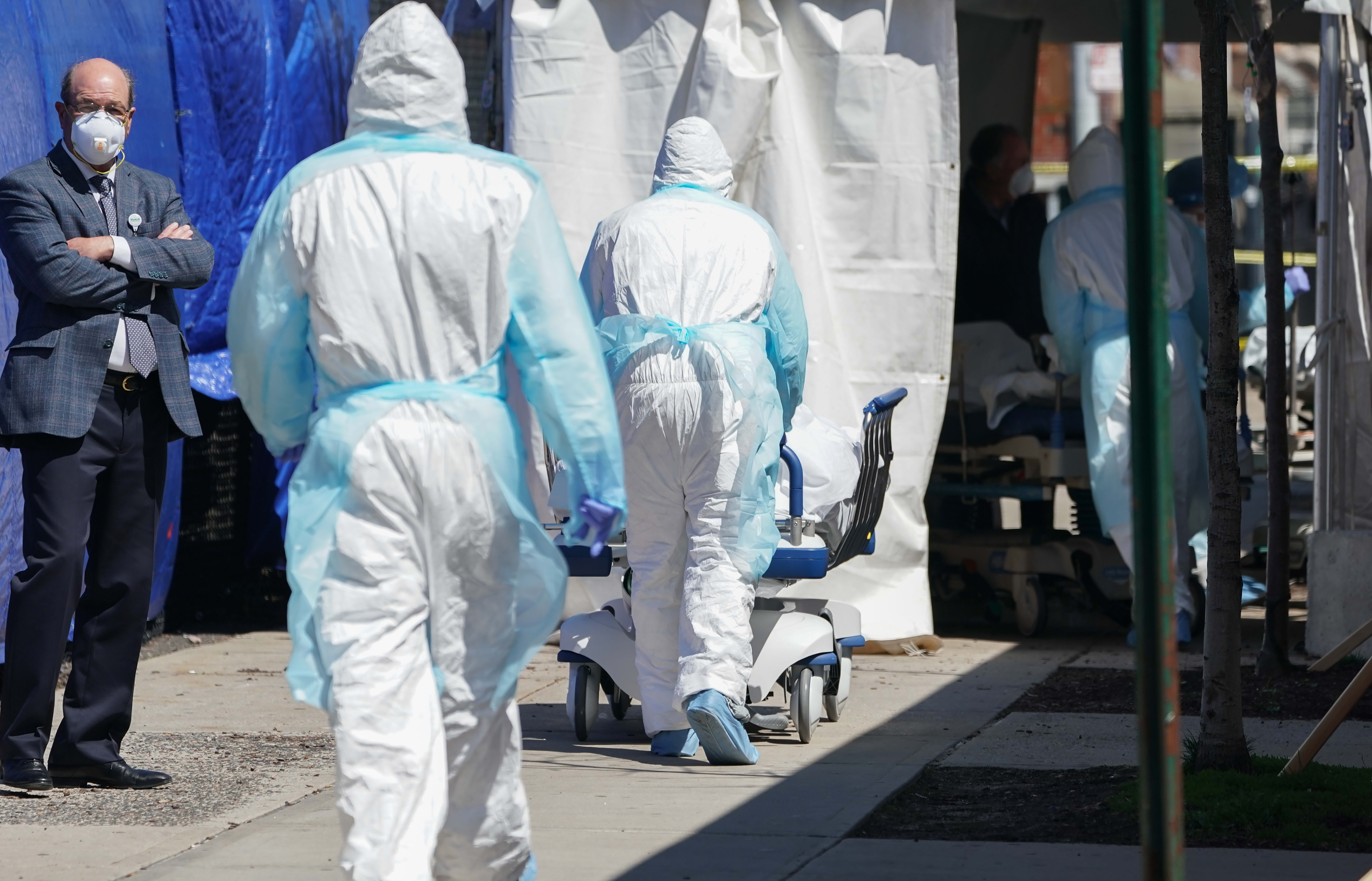 Bodies are moved to a refrigeration truck serving as a temporary morgue at Wyckoff Hospital in the Borough of Brooklyn on April 6, 2020 in New York.