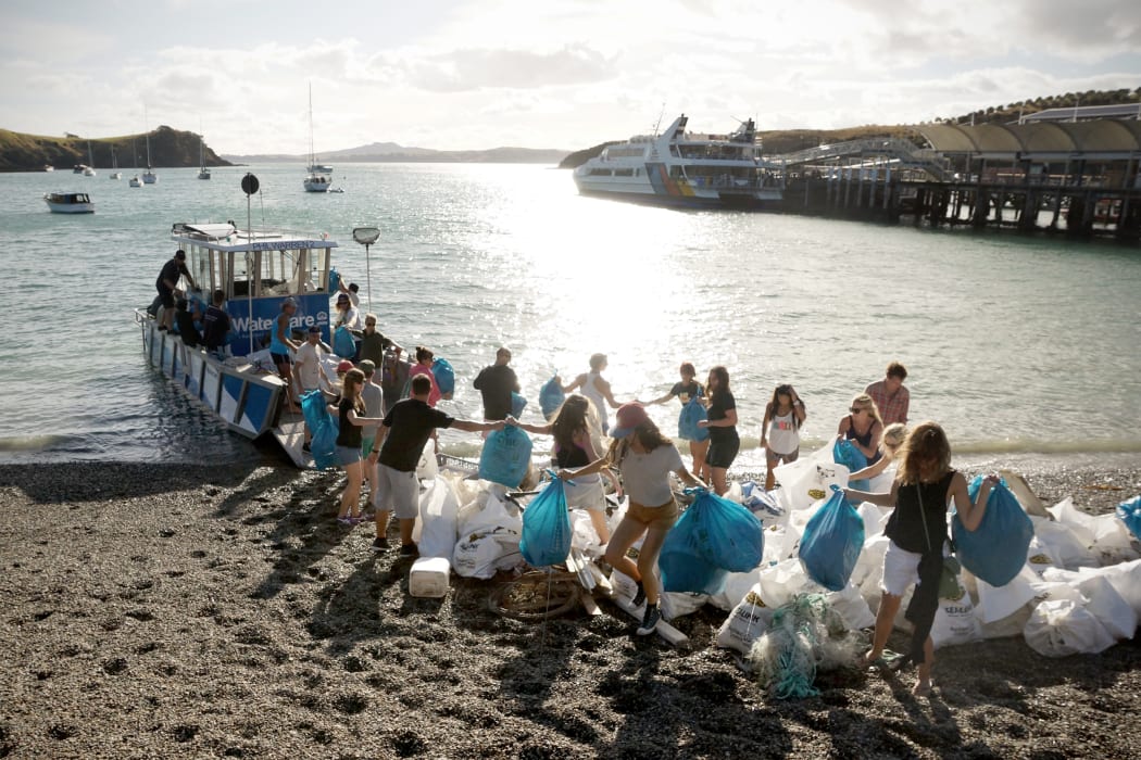 Captain Hayden Smith and a team of volunteers unload bags of rubbish collected in the Waitemata Harbour.
