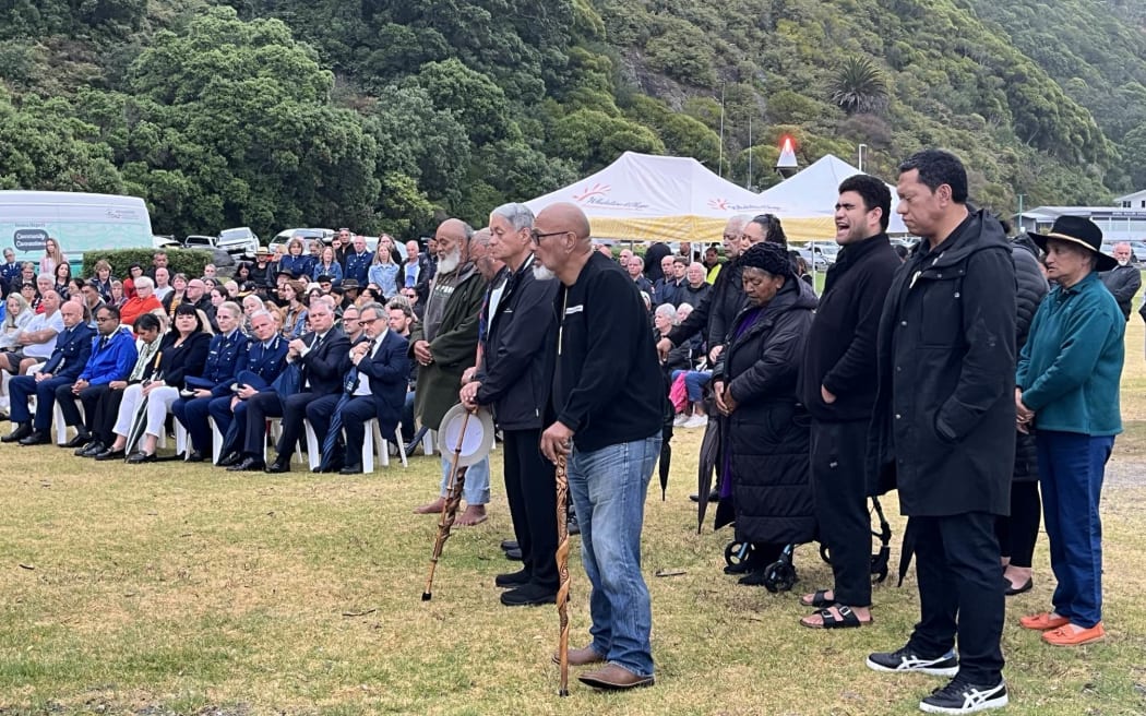 Whakatāne community sitting at the waterfront as karakia is held to mark the anniversary of the Whakaari White Island Eruption.