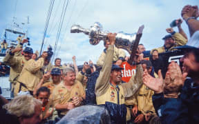 Sir Russell Coutts lifts the Auld Mug.