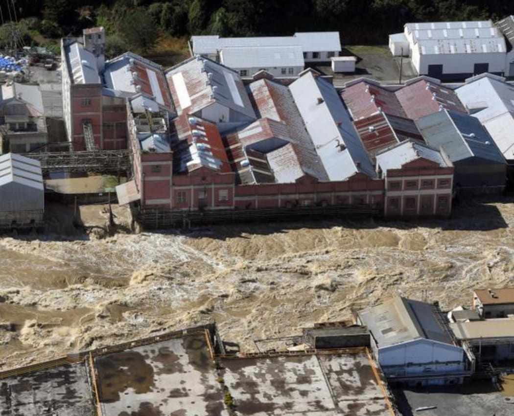 The flooded Mataura River rips past the former Mataura paper mill