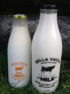 Raw milk and pasteurised milk in glass bottles.