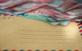 Piggy bank and a bundle of dollars from New Zealand. Money savings concept
