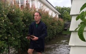 Brennan Fell outside his flooded Mt Albert house.