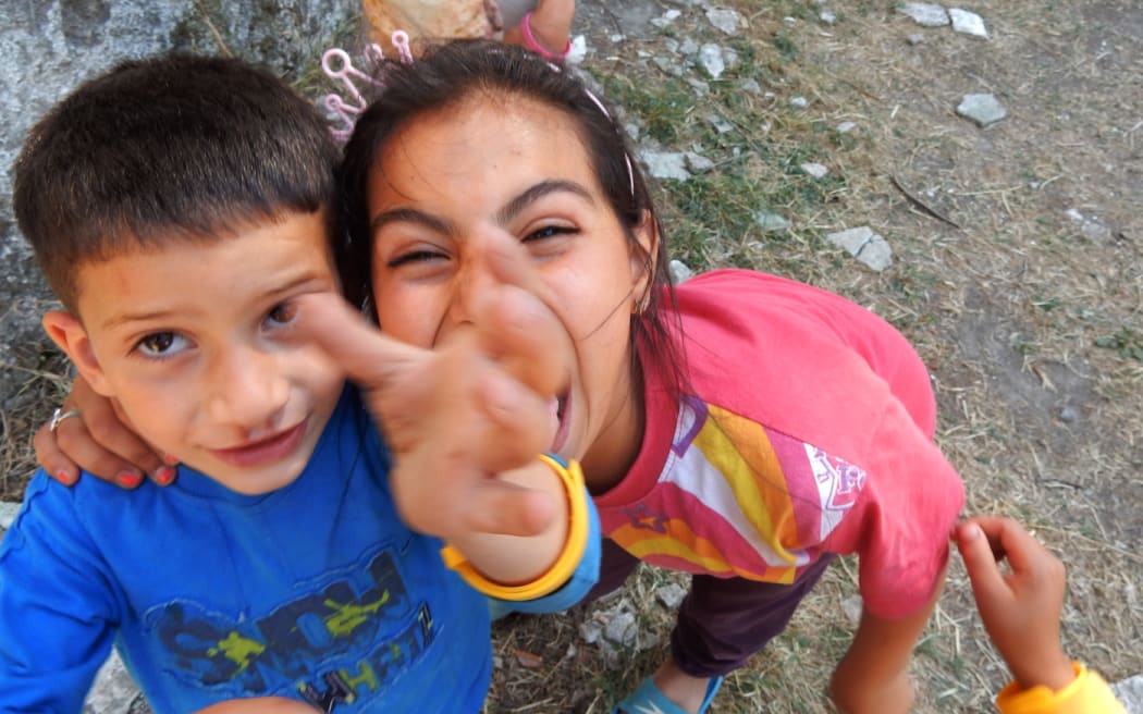 Children at the Ritsona refugee camp make faces for the camera.