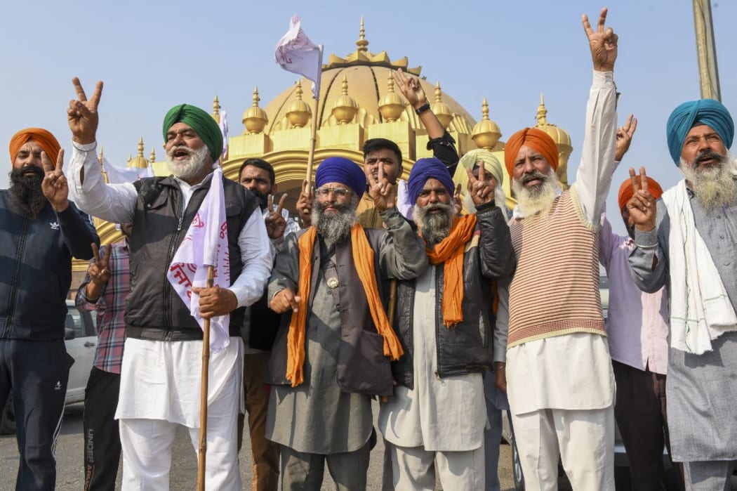 Farmers shout slogans to celebrate after India's Prime Minister announced to repeal three agricultural reform laws that sparked almost a year of huge protests across the country in Amritsar on November 19, 2021.