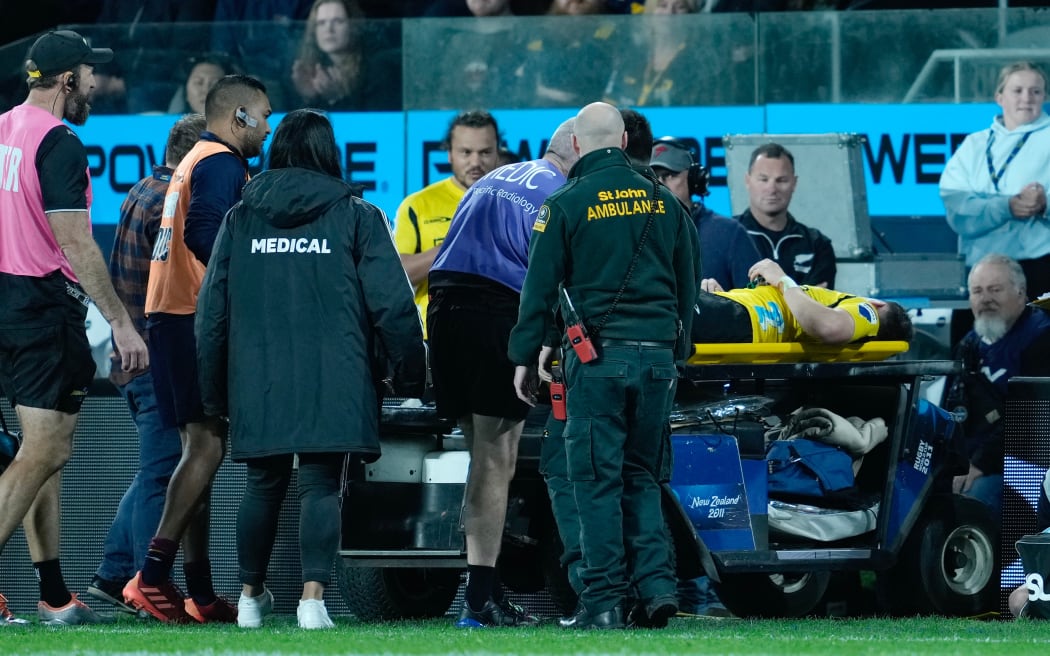 Hurricanes halfback Cam Roigard is taken from the field after suffering a serious knee injury against the Highlanders.