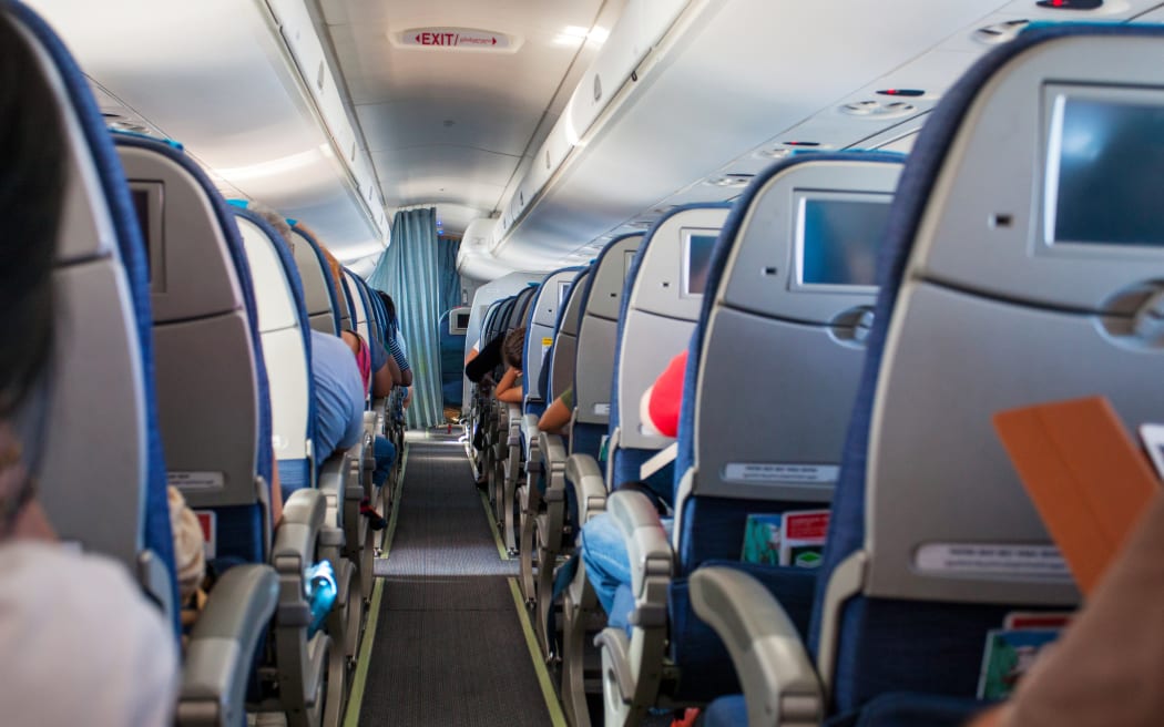 Passengers in seats on an airplane.