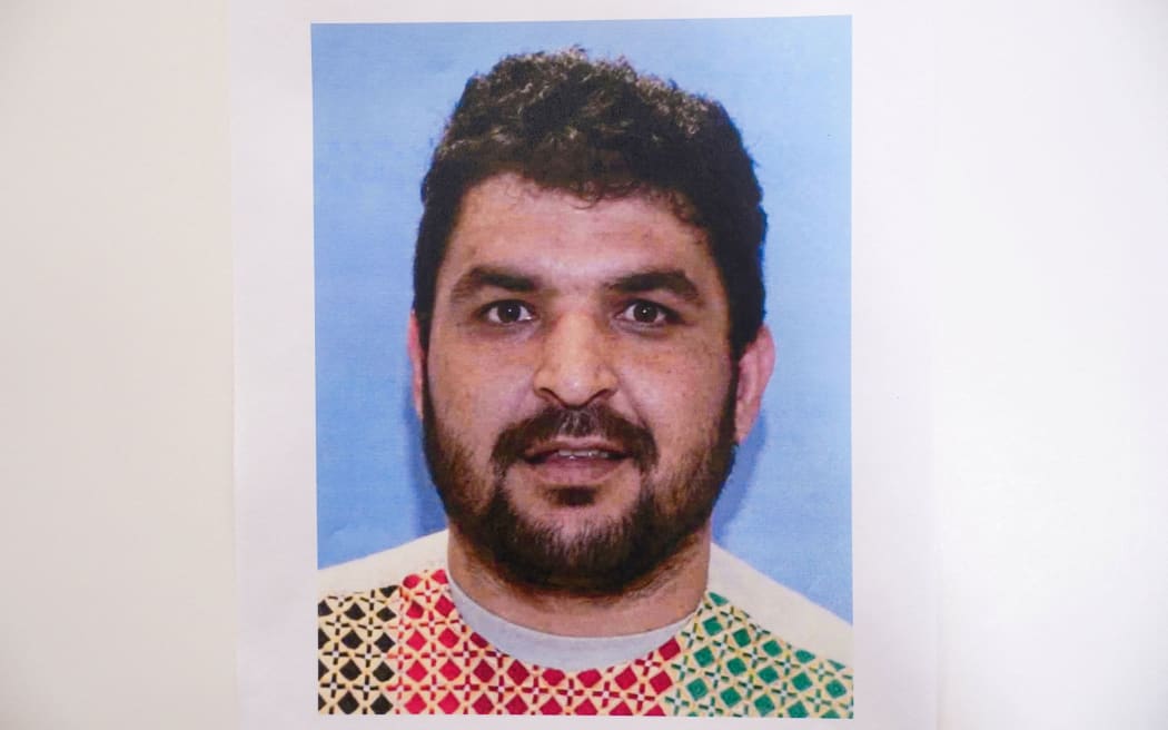 A picture of Rahmanullah Lakanwal, an Afghan national who is the suspect in the shooting of two National Guard members, is displayed at a press conference in Washington, DC, on November 27.