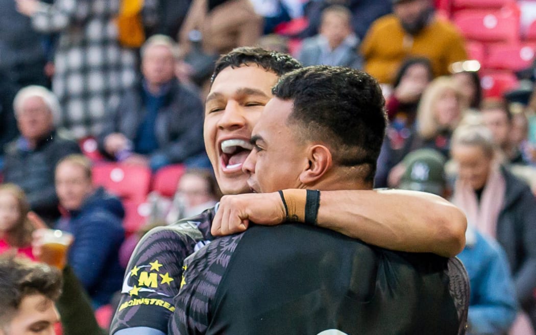 Kiwis New Zealand's Ken Maumalo is congratulated by captain Dallin Watene-Zelezniak.