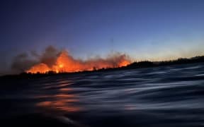 A large fire in West Melton, pictured from the north side of the Waimakariri River.