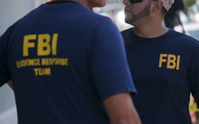 Members of the FBI are seen as they work with French authorities to conduct a raid to recover art at the headquarters of the Michele Vasarely Foundation in San Juan, Puerto Rico, on April 11, 2023. - The raid, according to local sources, is related to an investigation into the whereabouts of hundreds of works of art by French-Hungarian artist Victor Vasarely and his son Yvaral Vasarely, valued at more than $40 million dollars. (Photo by Ricardo ARDUENGO / AFP)
