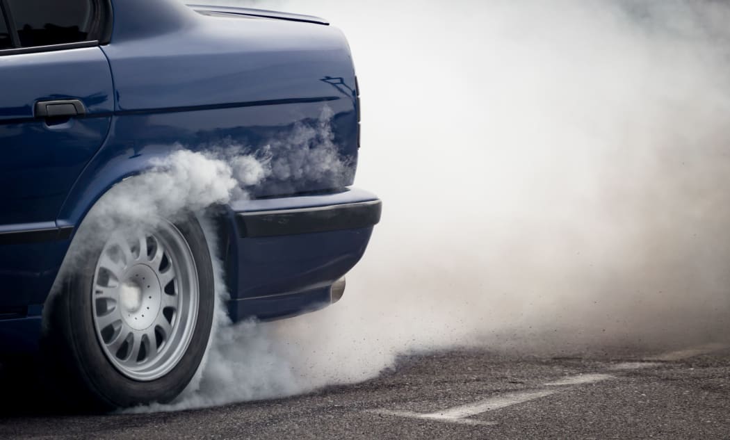 Smoke from under the wheels of the car