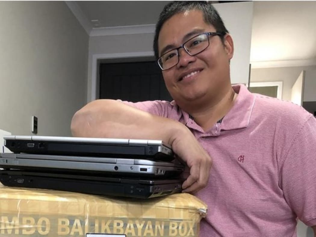 Ronan Yabut with a package ready to be sent to the Philippines.
