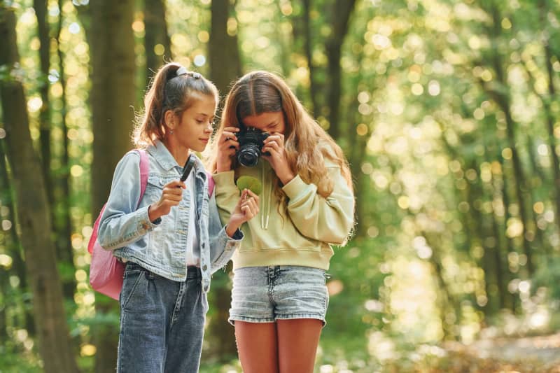 Two young girls exploring outside.