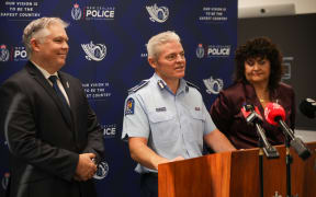 Police Commissioner Richard Chambers speaks to media while Police Minister & Associate Police Minister Mark Mitchell and Casey Costello look on.