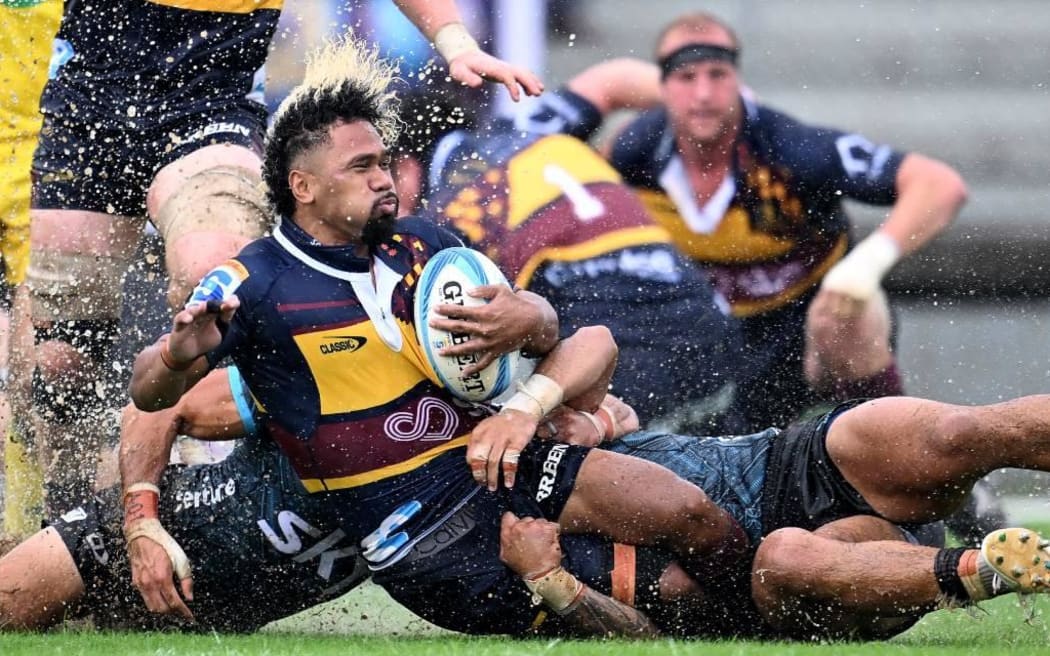 Folau Fakatava slides in the rain in Tonga on Saturday as the Highlanders won the clash against Moana Pasifika.