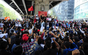 People holding placards shout slogans of anti-coup as they protest against the military coup.