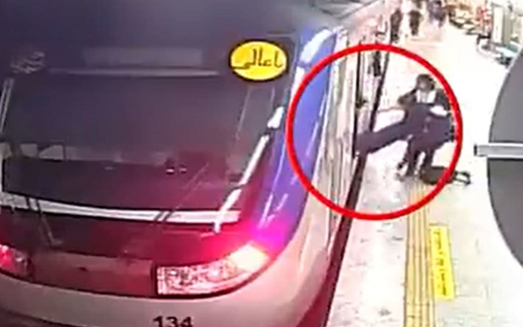 CCTV footage released by authorities shows a girl being pulled unconscious from the metro train in Tehran.