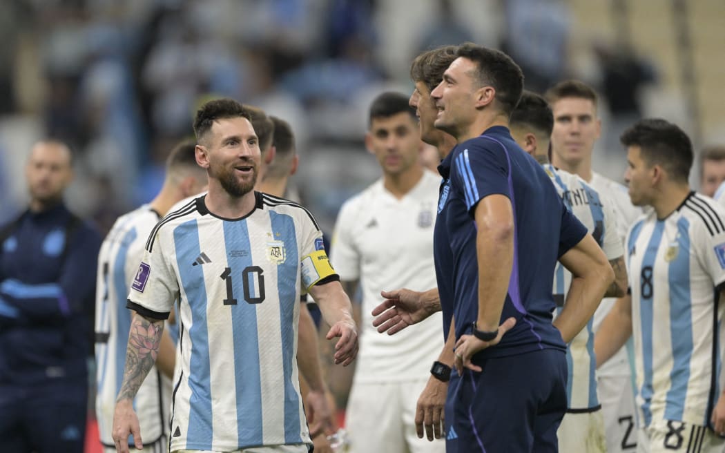 Argentina's forward captain Lionel Messi celebarates with Argentina's coach Lionel Scaloni after winning the Qatar 2022 World Cup quarter-final football match against The Netherlands.
