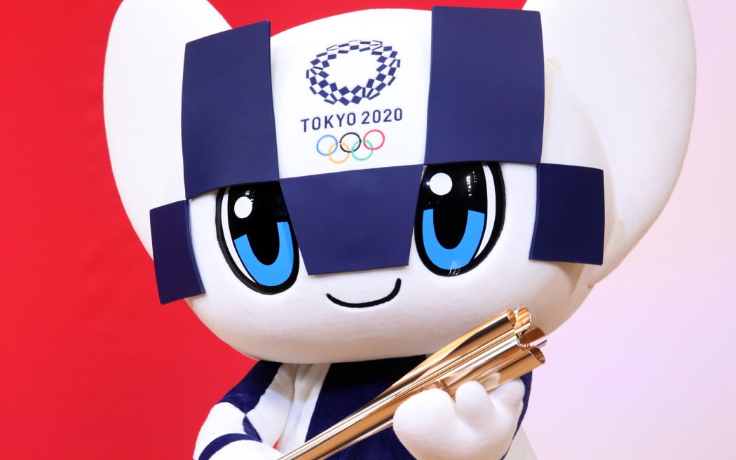 Tokyo Olympics mascot Miraitowa displays an Olympic torch.