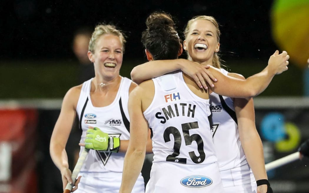 Kelsey Smith is congratulated by Kirsten Pearce after scoring for the Black Sticks.