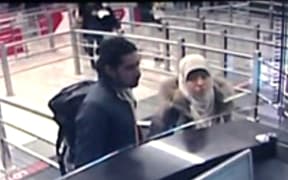 The footage appears to show Hayat Boumeddiene (right) presenting her passport at Sabiha Gokcen airport in Istanbul on 2 January.