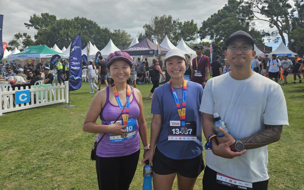 Sarah, with friends Carlo and Suzanne, says she does Round the Bays to have fun with friends.