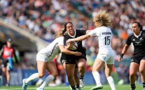 Sylvia Brunt of New Zealand is tackled by England defenders.