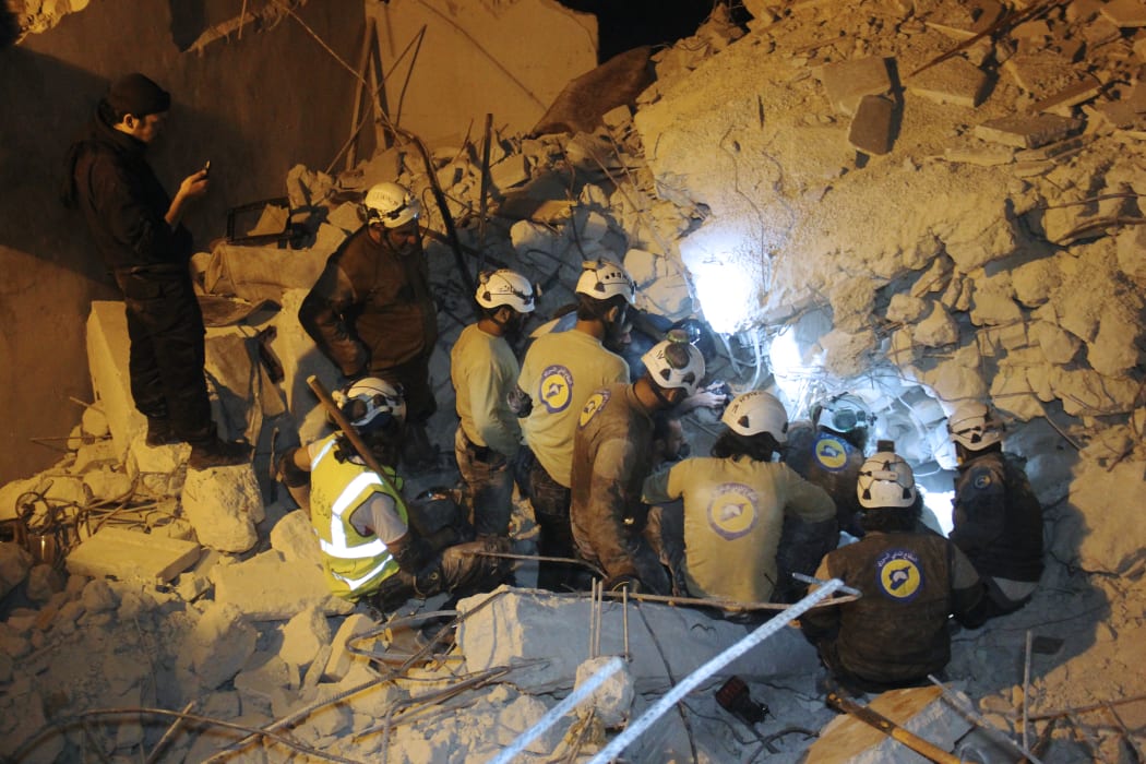 White Helmets search for survivors amid the rubble of destroyed buildings following air strikes on the Syrian northwestern city of Idlib in June this year.