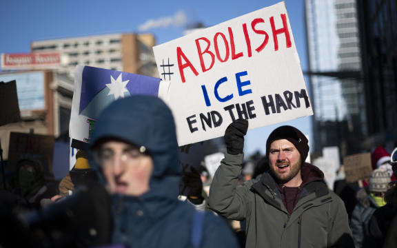 Protesters against Immigration and Customs Enforcement (ICE) march through the streets of downtown Minneapolis, Minnesota, on January 25, 2026. On January 24, federal agents shot dead US citizen Alex Pretti, a 37-year-old ICU nurse, while scuffling with him on an icy roadway, less than three weeks after an immigration officer shot and killed Renee Good, also 37, in her car. His killing sparked new protests and impassioned demands by local leaders for the Trump administration to end its operation in the city. (Photo by ROBERTO SCHMIDT / AFP)