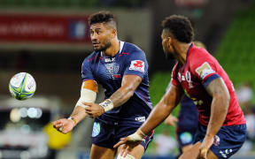 Amanaki Mafi (left) of Melbourne Rebels passes the ball during the Melbourne Rebels vs Queensland Reds in the Vodafone Super Rugby at AMMI Park, Melbourne, Australia on 23 February 2018.