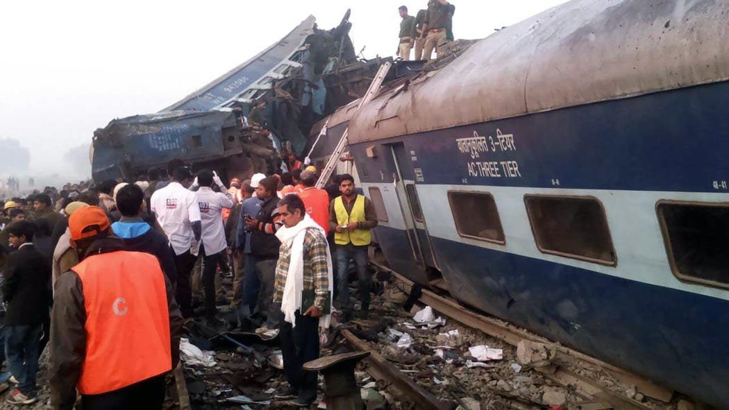 Indian rescue workers search for survivors in the wreckage of the derailed train.